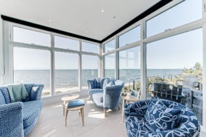 Image of a sitting area in a 2-story contemporary style home overlooking the ocean in Brewster, MA.